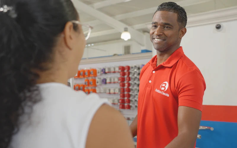 Better Deals team member helping a customer in store